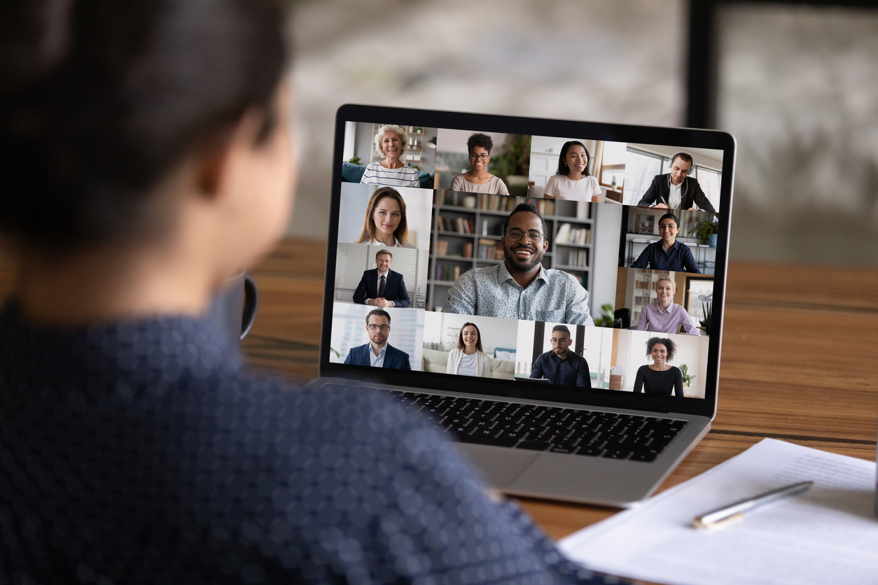 Rear view of woman talk on video call with colleagues virtual conference event